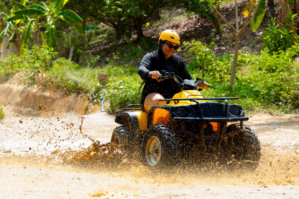 A tourist enjoying a Phuket ATV Tour in the rainforest