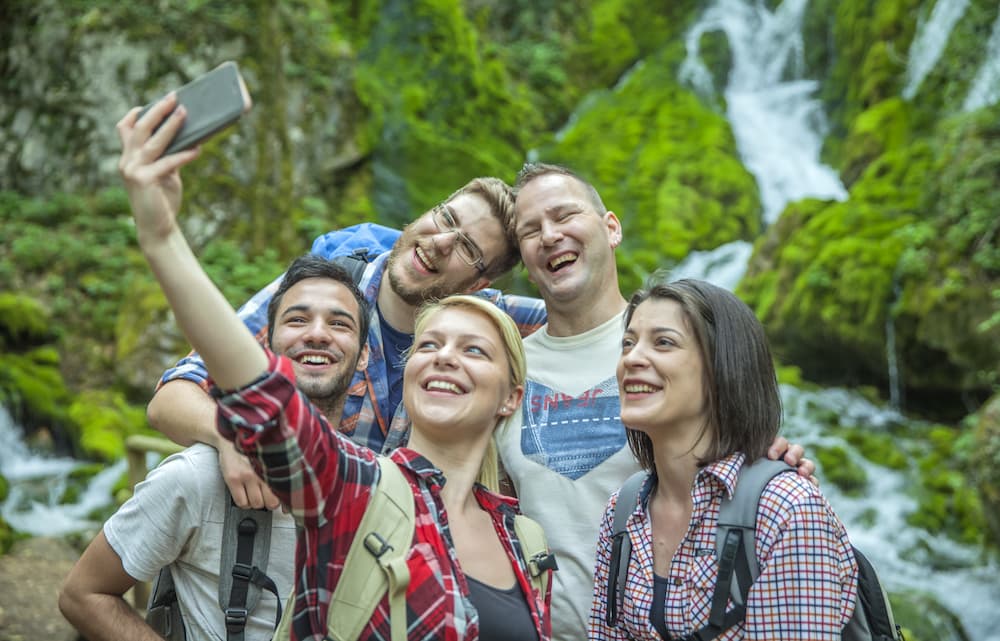 1706609186 group friends having fun taking selfies nature
