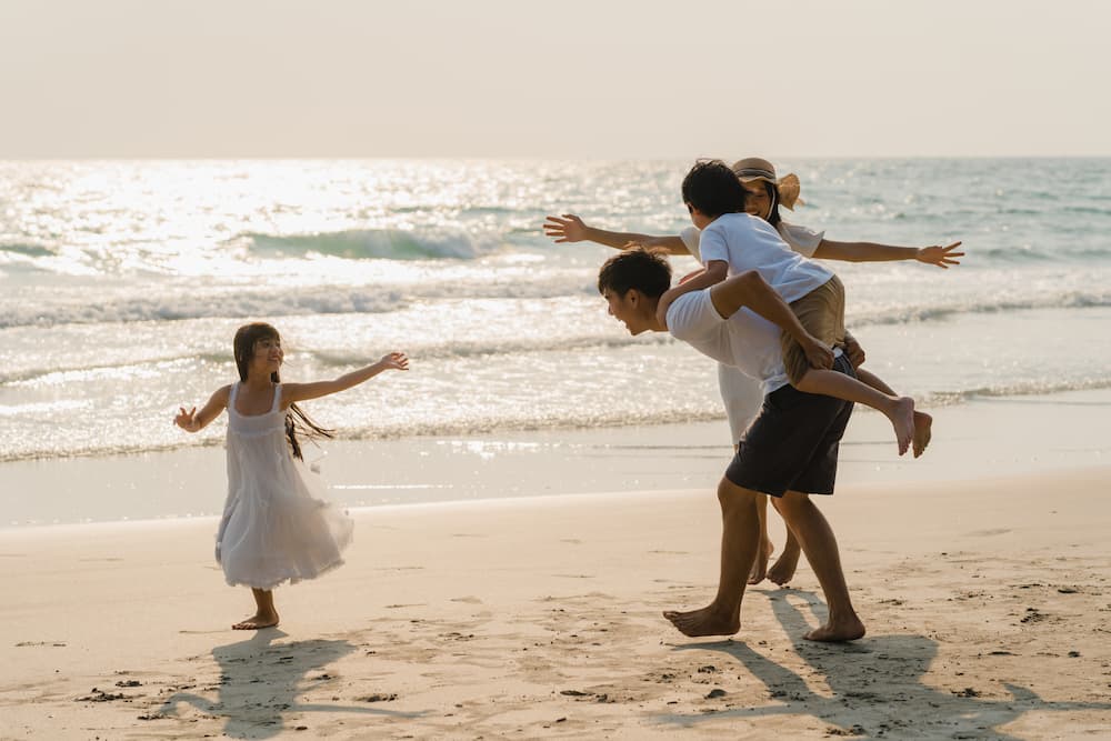 1706609201 asian young happy family enjoy vacation beach