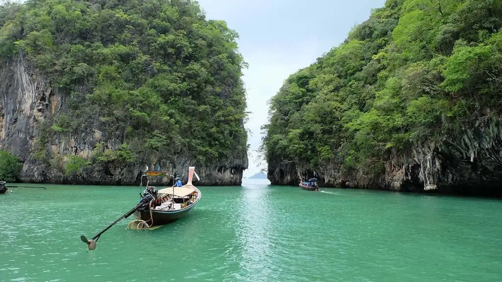 Hong Island: Emerald lagoon surrounded by towering limestone cliffs like a natural chamber.