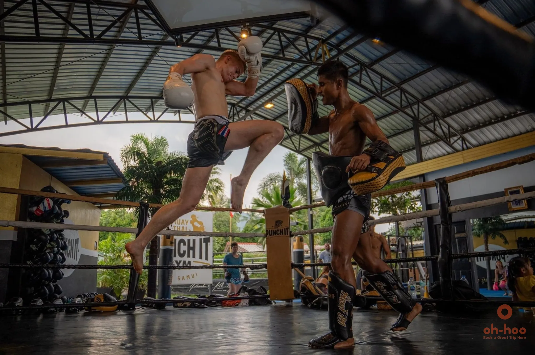 Tourist learning Muay Thai with a professional Thai fighter during a training class in Koh Samui