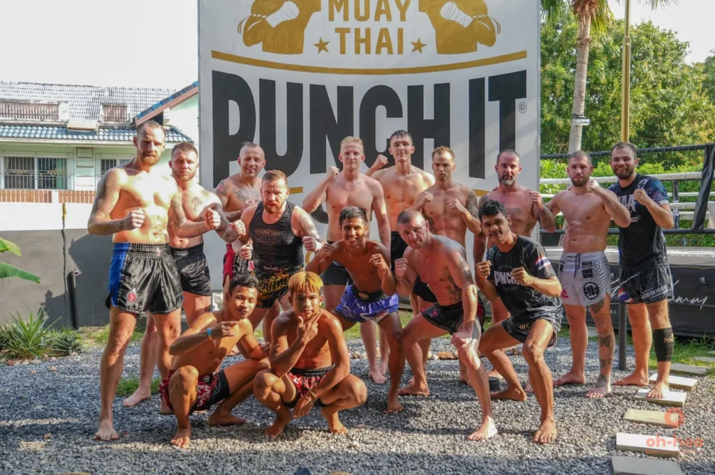 Happy tourists posing with their Muay Thai trainer after completing a training class in Koh Samui with Oh-Hoo Tours