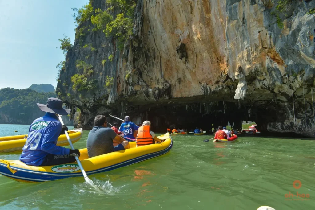 Travellers canoeing through a sea cave on a James Bond Island tour in Phang Nga Bay, Phuket