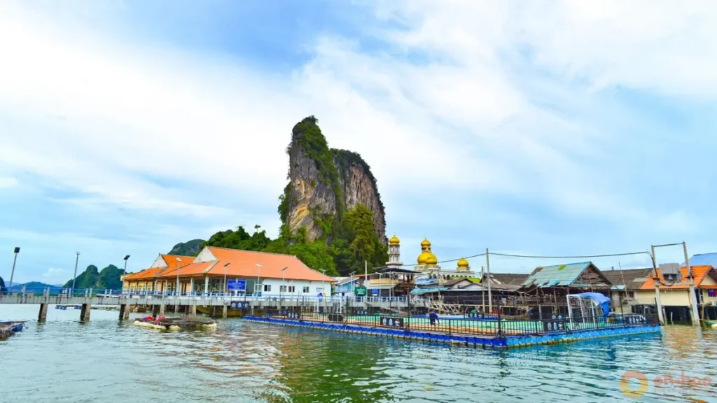 Panyee Village floating village stop during a Phang Nga Bay tour with mosque, stilt houses, and limestone mountain backdrop