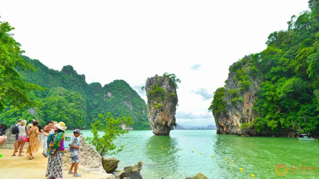 James Bond Island viewpoint with tourists, emerald water, and limestone rock formations on a Phang Nga Bay tour Phuket