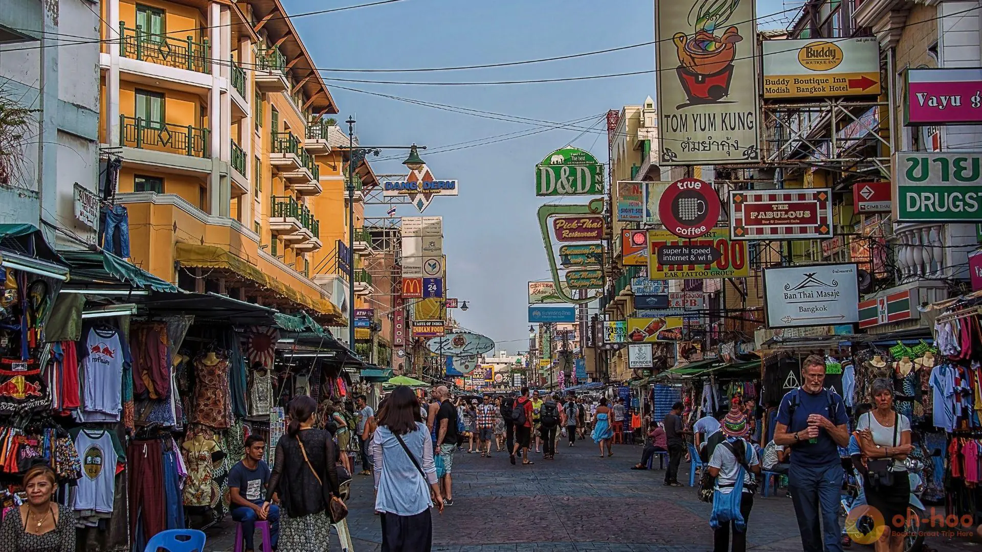 Crowds walking along Khao San Road in Bangkok, Thailand with shops, street signs, and nightlife area