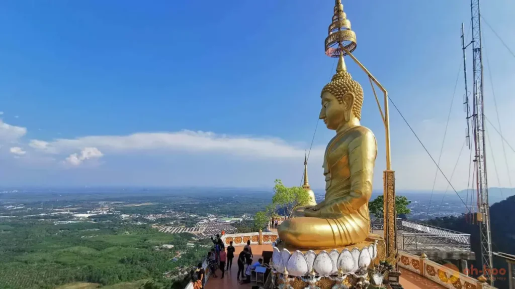 The golden Buddha at Tiger Cave Temple in Krabi, Thailand, overlooking a panoramic mountain and jungle viewpoint, highlighting temple visits and scenic viewpoints as one of the best things to do in Krabi.