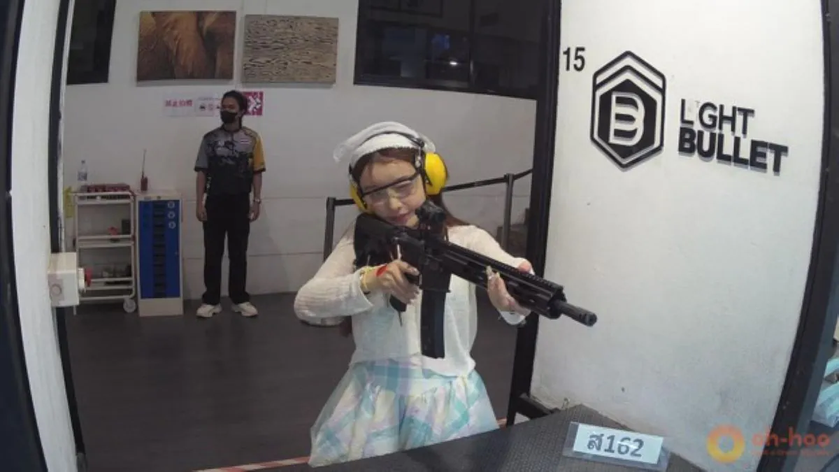Travelers practicing target shooting at a professional indoor shooting range