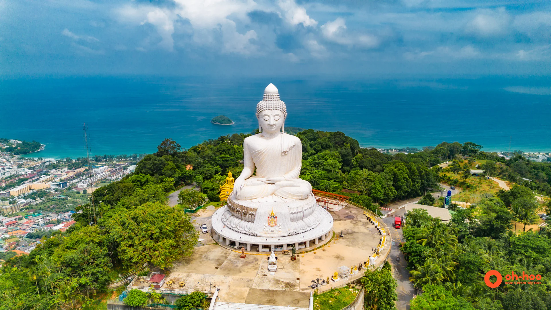 The white marble Big Buddha Phuket statue on Nakkerd Hill against a blue sky