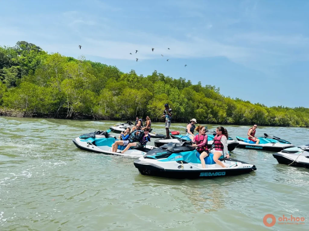 Group riding Sea-Doo jet skis through a mangrove channel on a guided Phuket jet ski tour