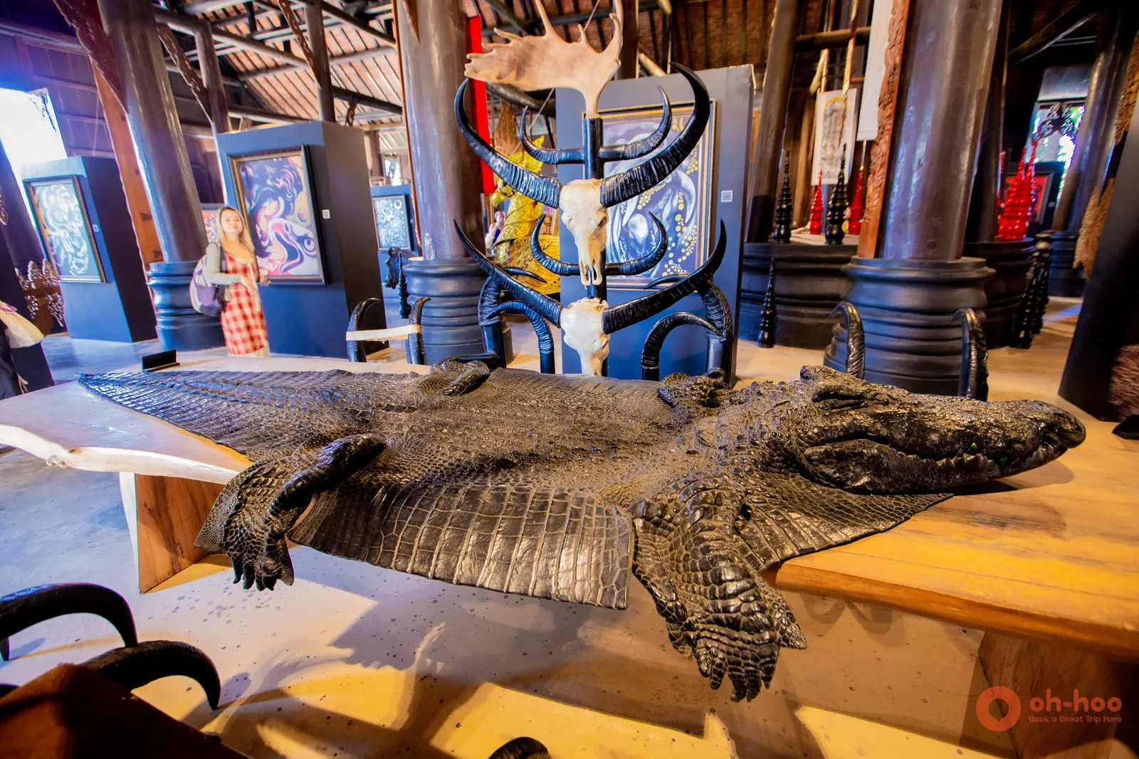 Dark teak interior of the Black House (Baan Dam) with animal hides and art near Chiang Rai