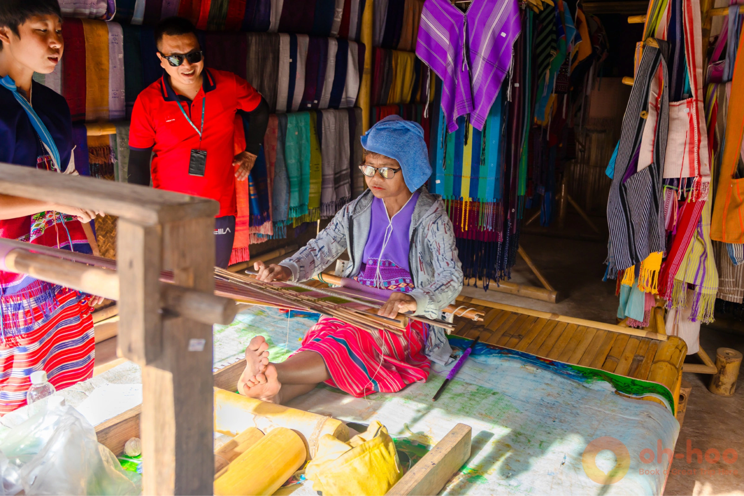 Karen hill tribe villager weaving traditional textiles at a village stop on the Doi Inthanon day trip