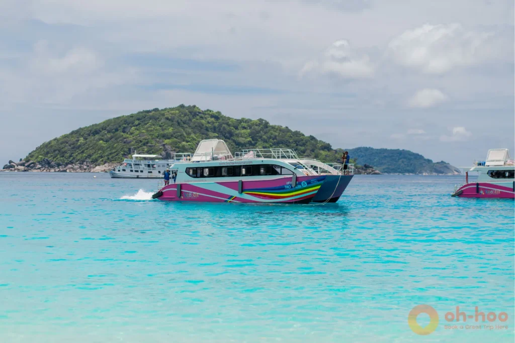 Speedboat cruising past granite boulders on the way to the Similan Islands from Khao Lak