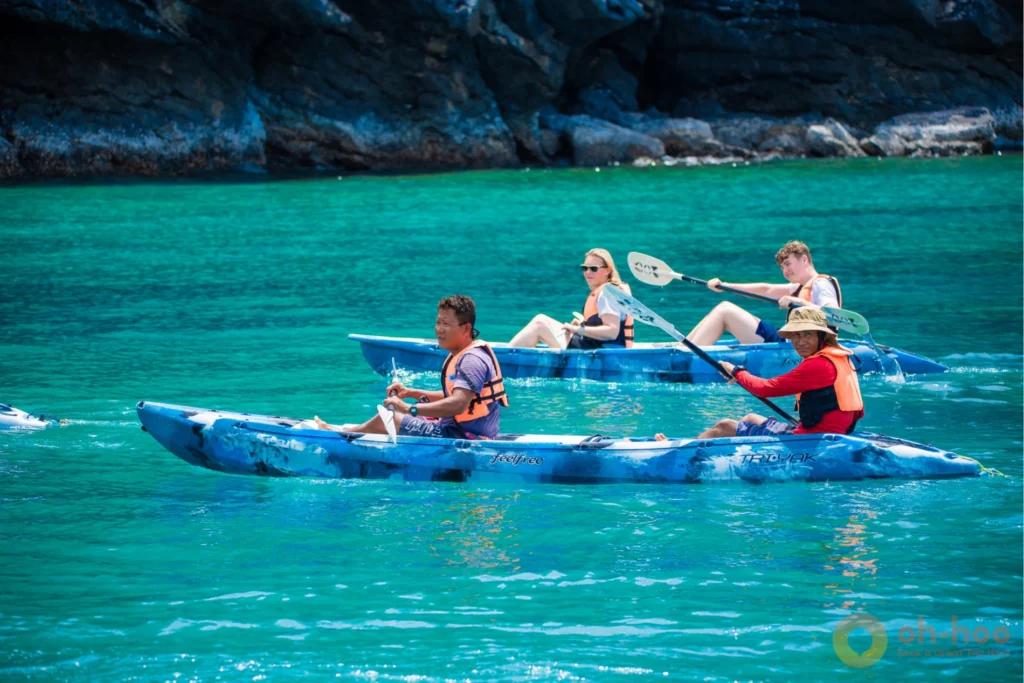 Tandem kayaks paddling through calm lagoon water on an Angthong kayaking tour from Koh Samui