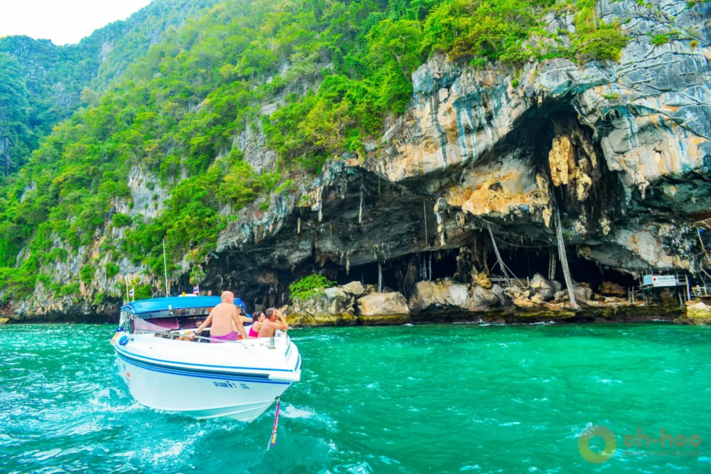 Speedboat cruising past Viking Cave cliffs during a Phi Phi Island tour