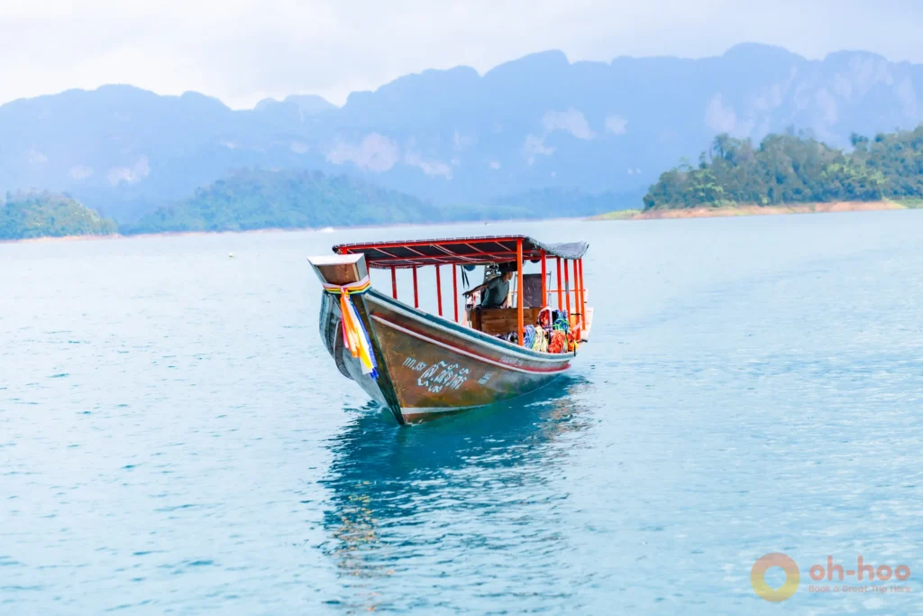 Traditional longtail boat cruising through emerald waters on a Cheow Lan Lake tour