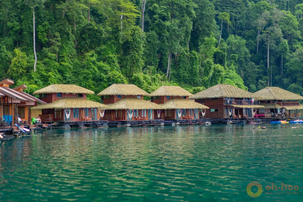 Floating raft house bungalows with kayaks on Cheow Lan Lake in Khao Sok