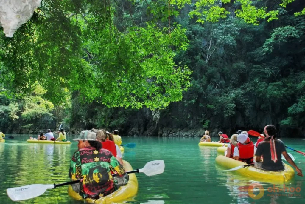 Canoeing through lush rainforest on a wildlife tour at Cheow Lan Lake in Khao Sok