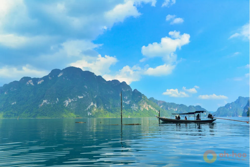 Long-tail boat tour passing scenic limestone karsts at Cheow Lan Lake in Khao Sok