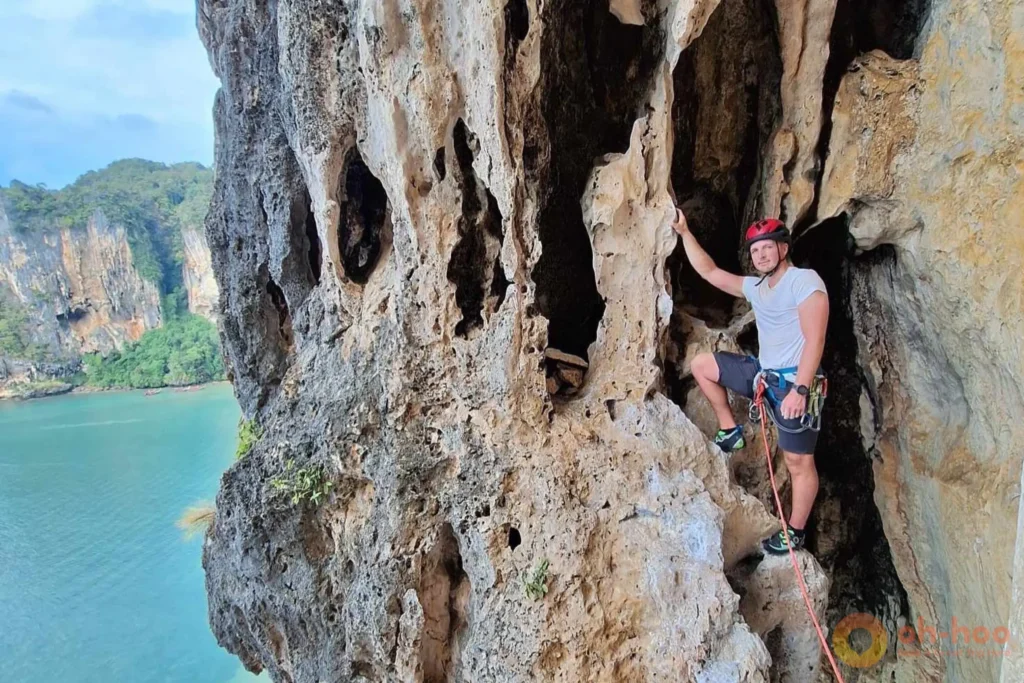 Tourists equipped with safety gear ready for a beginner Railay rock climbing session