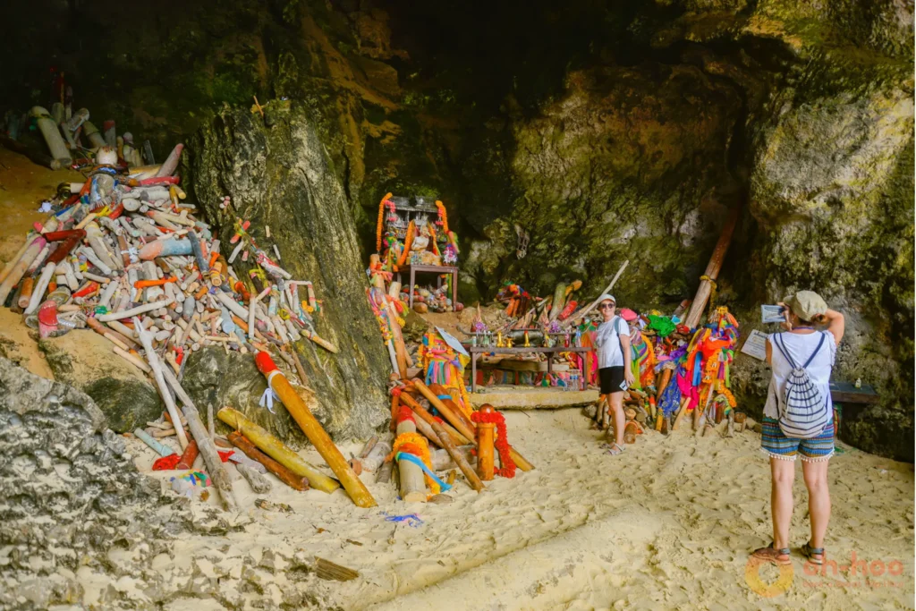 Phra Nang Cave Beach with massive limestone cliffs and tourists in Railay, Krabi