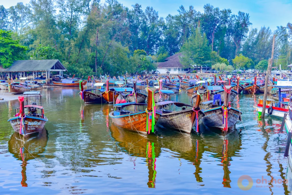 Rows of colourful traditional longtail boats moored at a Krabi harbour before a 4 Islands island-hopping tour