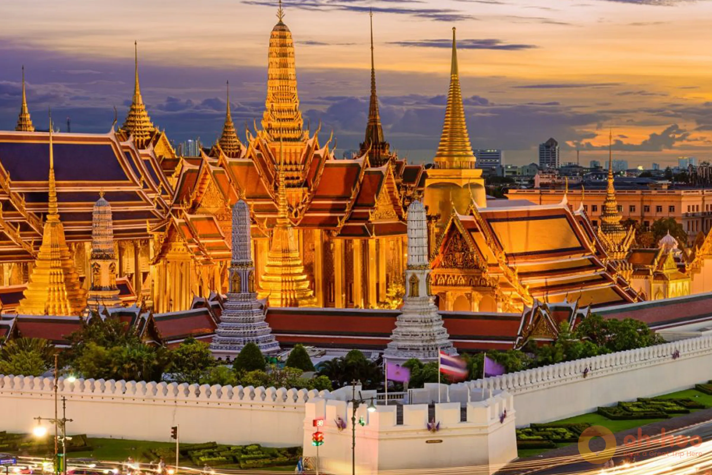 Golden chedis and ornate rooftops of Wat Phra Kaew and Grand Palace complex in Bangkok at sunset