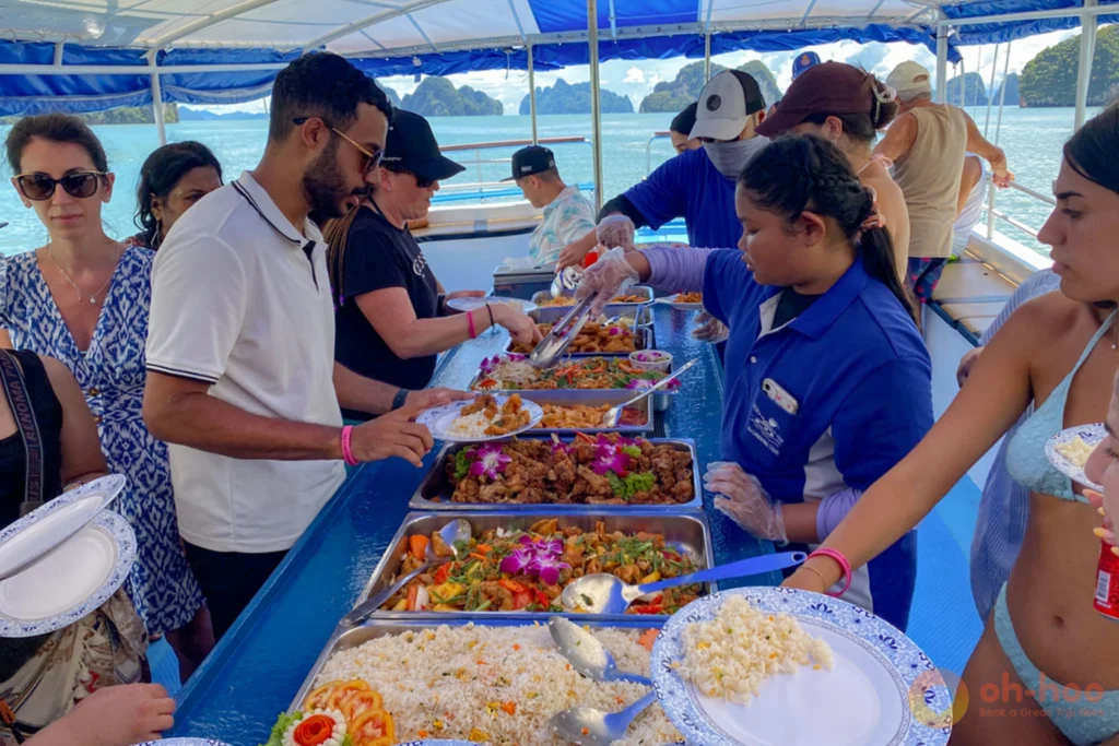 Tourists enjoying fresh halal seafood buffet on a Phang Nga Bay day trip boat
