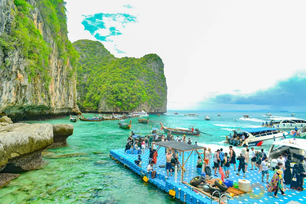 Tourists arriving at the floating pontoon pier in Loh Samah Bay behind Maya Bay