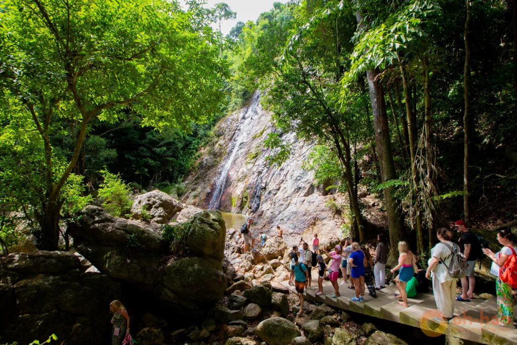 Tourists walking along the jungle path towards Na Muang Waterfall in Koh Samui.