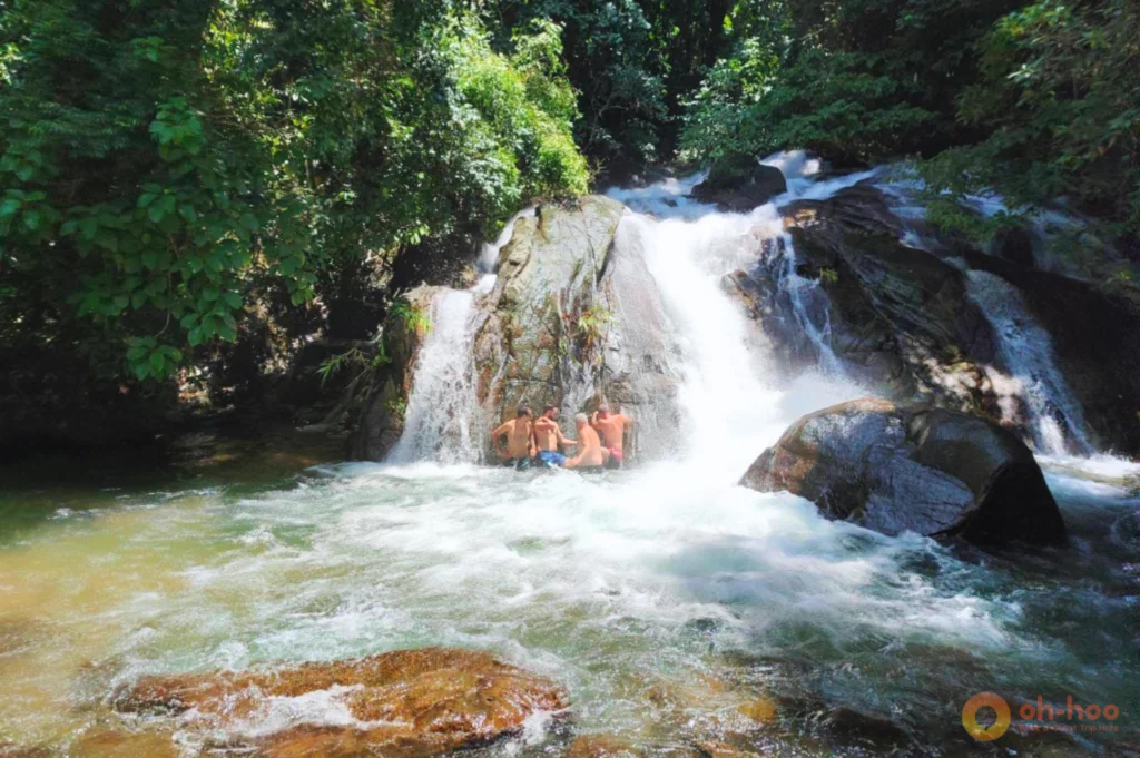 Traveller swimming in a jungle waterfall pool after a Khao Lak ATV ride