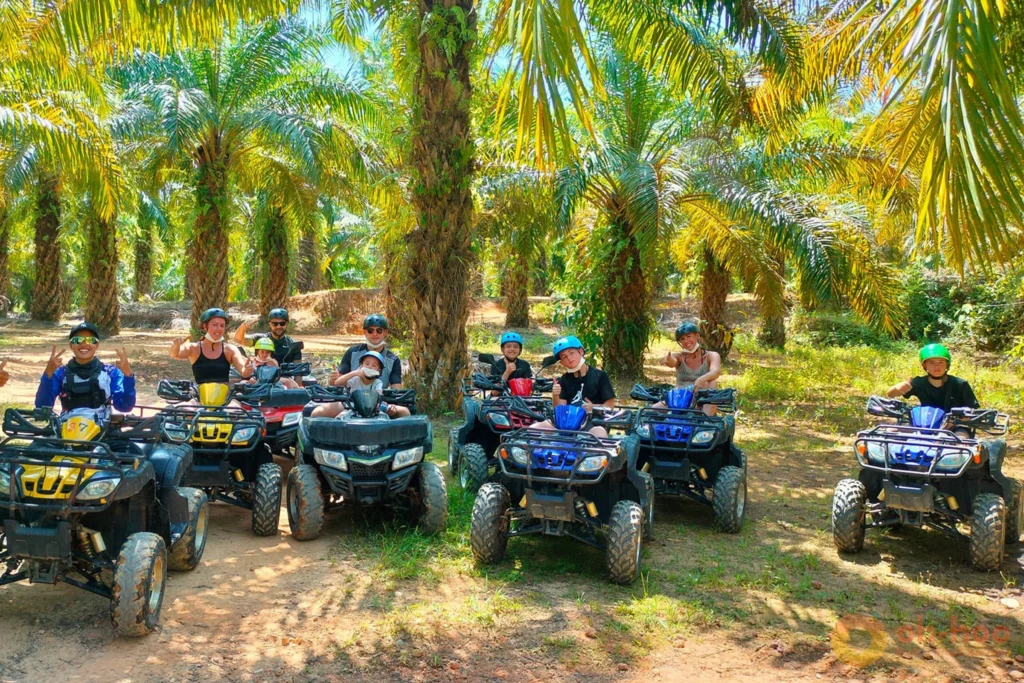 Group of riders with their guide beside ATVs on a Khao Lak jungle trail