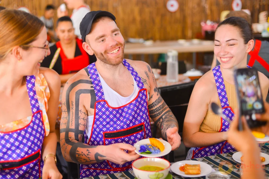 Group of travellers sharing and enjoying the Thai dishes they cooked together at an Ao Nang cooking class
