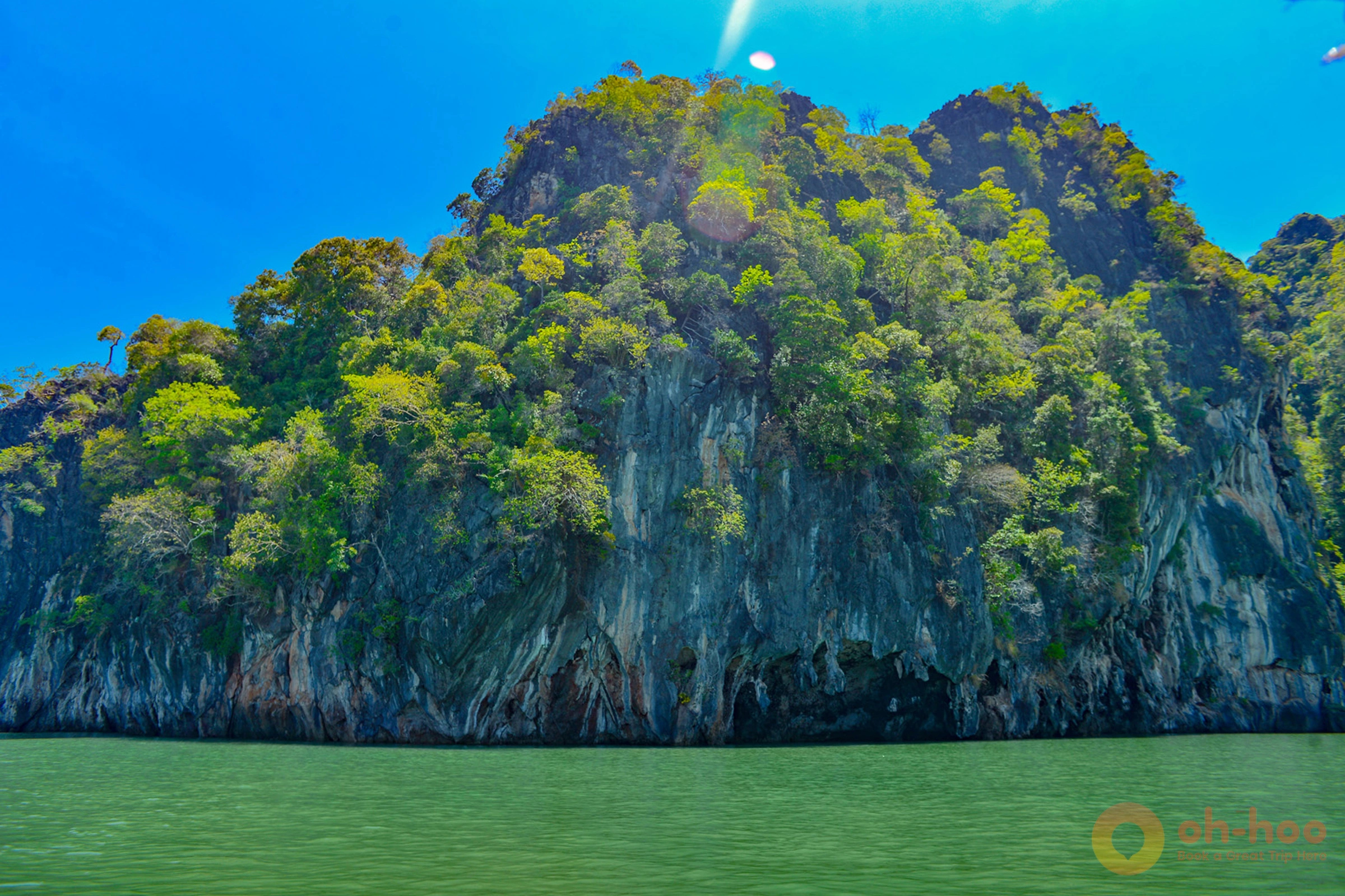 Emerald-green hidden lagoon inside Morakot Cave on Koh Mook, ringed by jungle cliffs