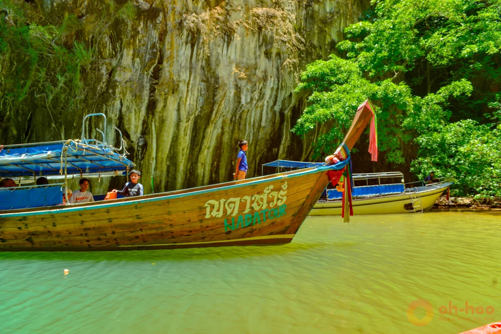 Traditional longtail boat anchored off a limestone island on the Koh Lanta 4 island tour