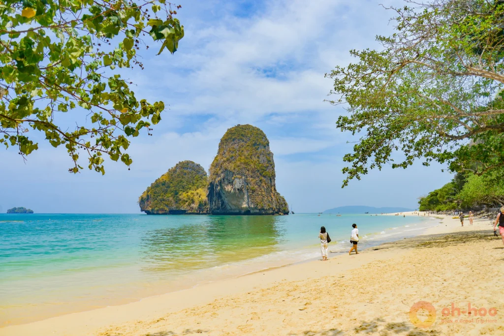 Turquoise water and sharp limestone cliffs under a clear blue Krabi sky in dry season