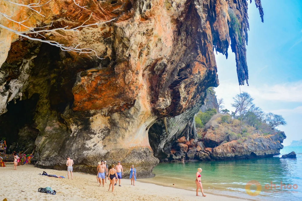 Sheer 200-metre limestone cliff towering over the white sand of Railay Beach