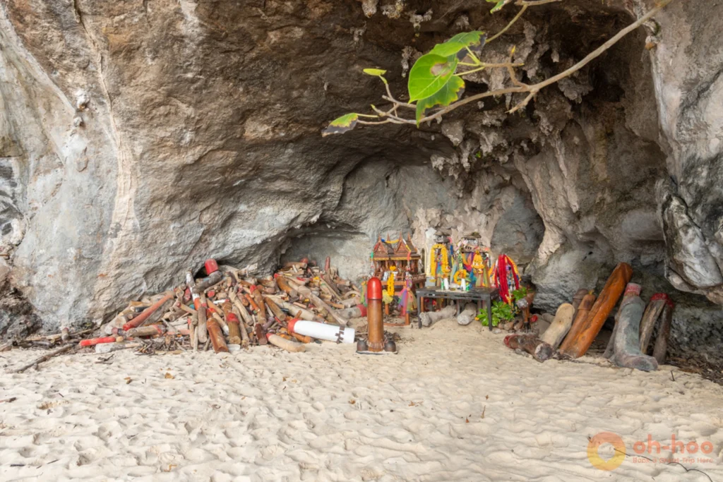 Wide view of the open-air Phra Nang Princess Cave shrine tucked beneath the cliff at Railay