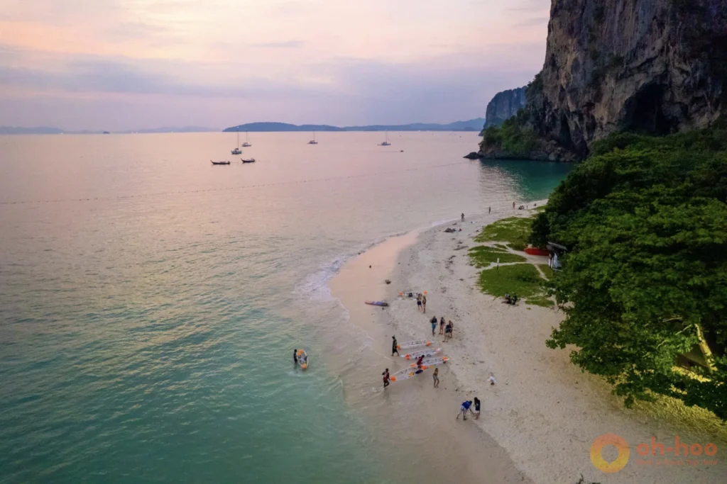 Fiery sunset over longtail boats on Railay West beach