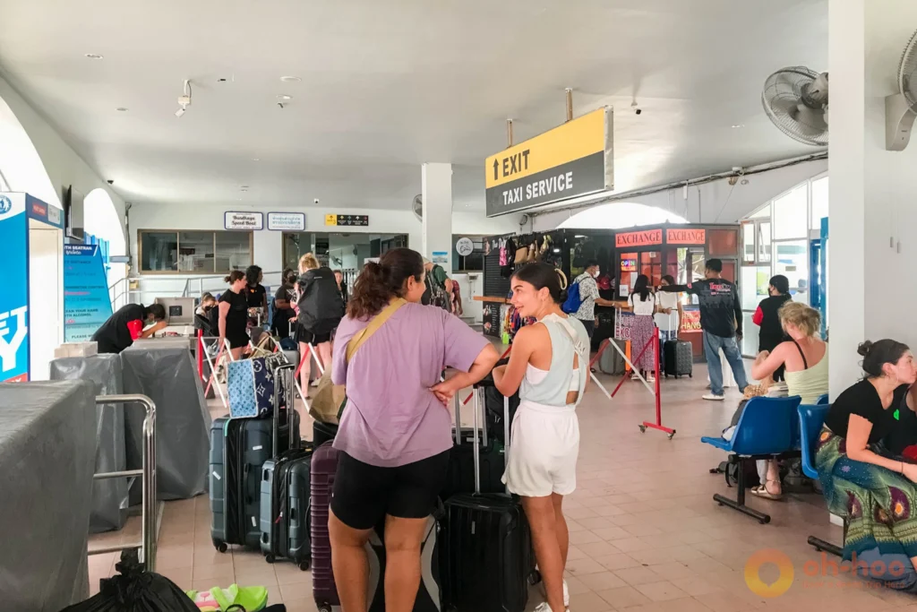 Ferry company check-in counters inside the Rassada Pier terminal building in Phuket