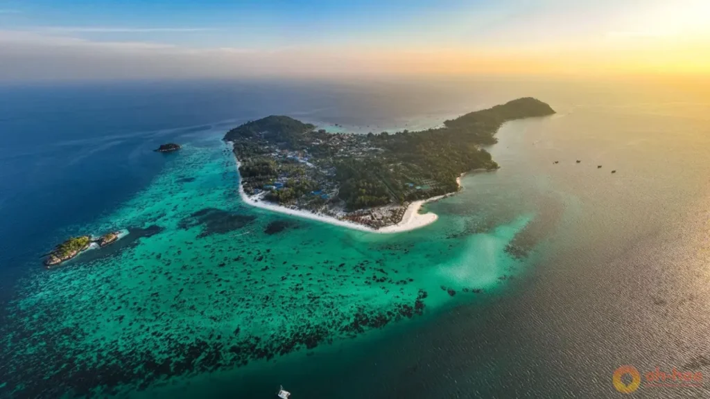Aerial view of Koh Lipe Thailand surrounded by turquoise water, coral reefs and white-sand beaches at sunset