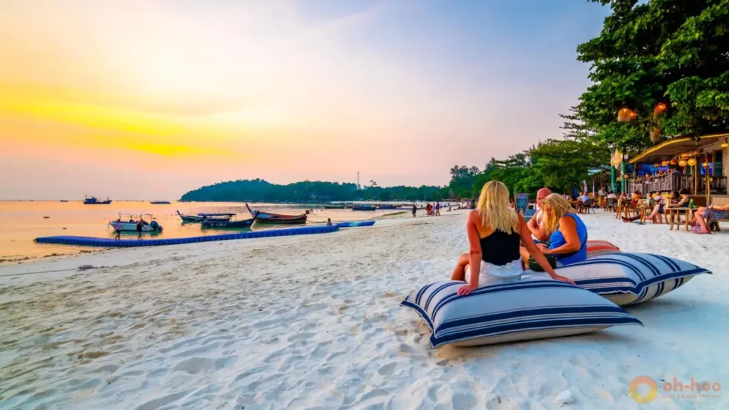 Pattaya Beach at sunset near Koh Lipe Walking Street, with white sand, longtail boats and beachfront restaurants