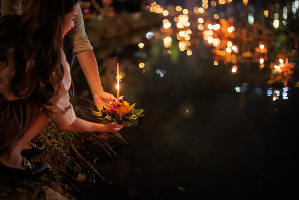 krathong floats drifting on the Ping River in Chiang Mai