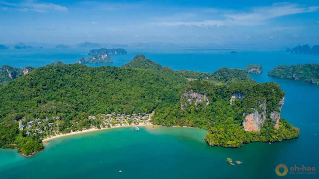 Elevated view of koh yao noi with a green limestone coastline, sheltered bay, and tropical landscape facing Phang Nga Bay.