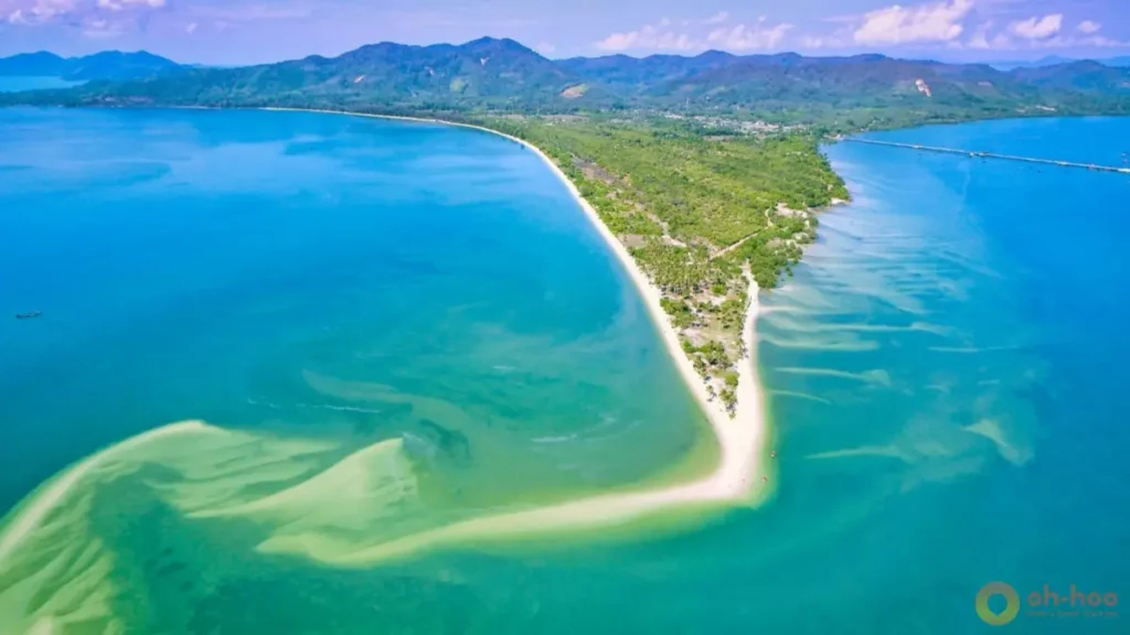 Aerial view of koh yao yai with a long sandy coastline, shallow turquoise water, and sandbars in Phang Nga Bay.