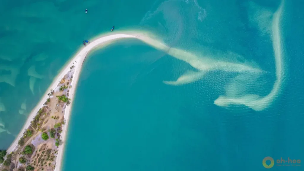 Aerial view of Laem Haad sandbar on Koh Yao Yai with shallow turquoise water and white sand stretching at low tide.