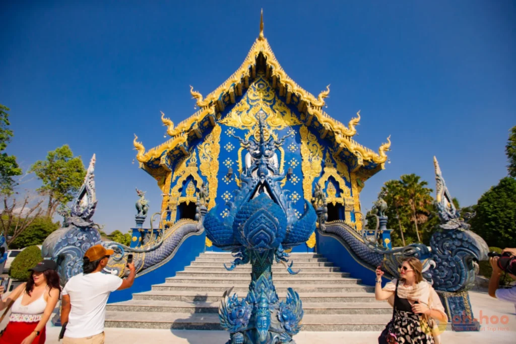 Blue and gold naga serpent staircase at the entrance to Wat Rong Suea Ten, Chiang Rai