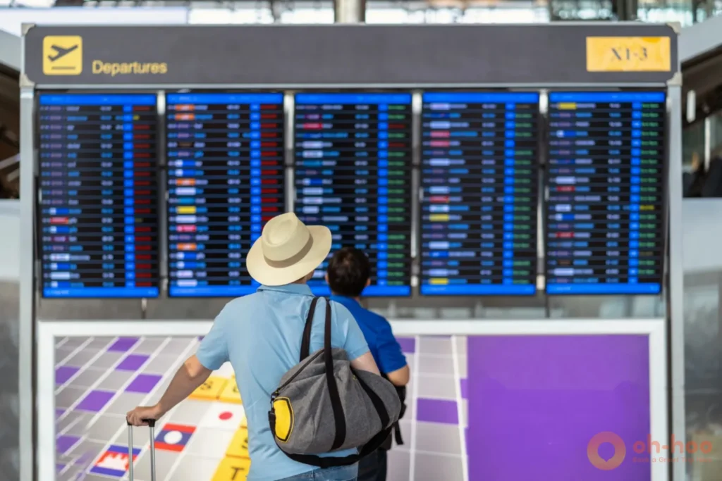 Departures board at Krabi International Airport showing a domestic flight to Koh Samui