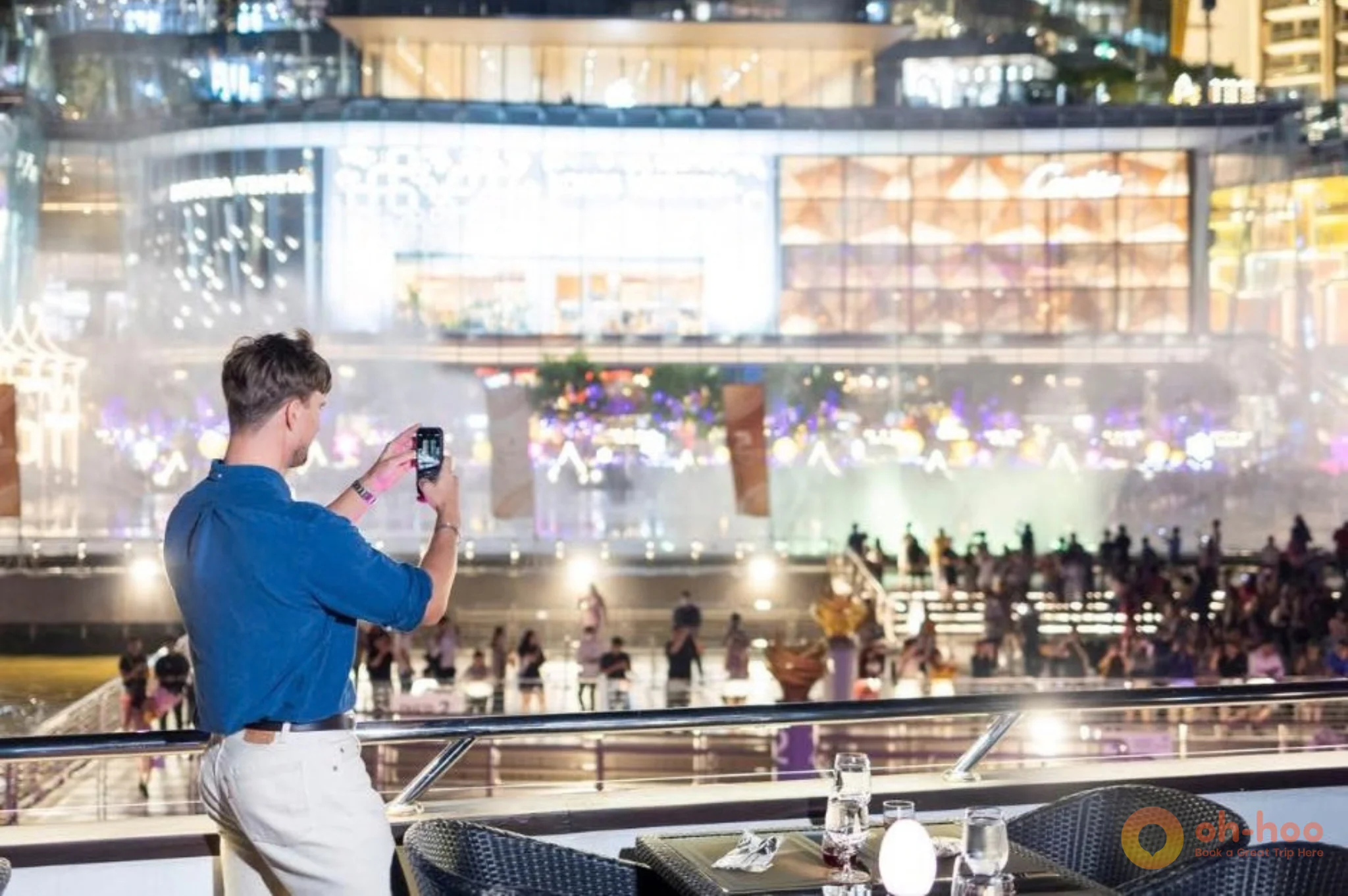 Guests watching the illuminated riverbank
