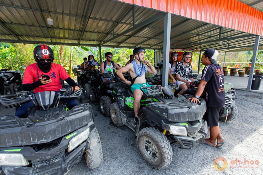 Guide briefing riders in helmets before the start of an ATV trail in Koh Samui